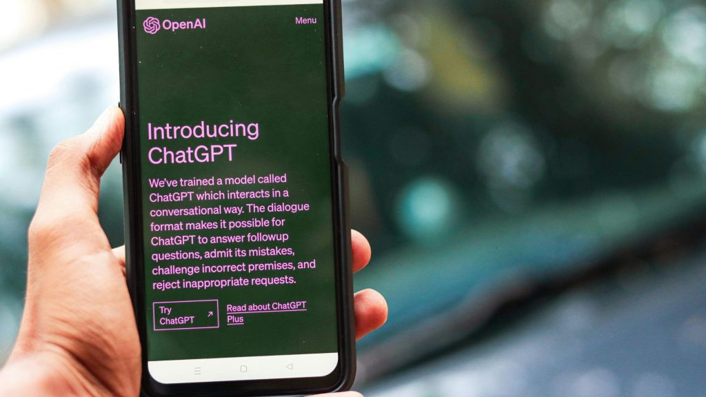 Shows someone holding up their phone using Chat GPT 