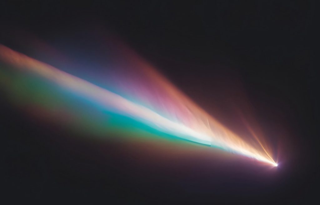 Shows a colourful lens flare effect on a dark background
